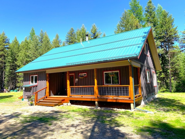 view of front of home featuring board and batten siding, metal roof, and a porch