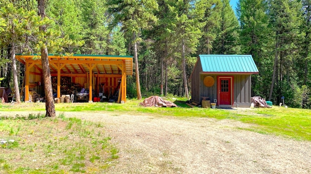 view of pole building with a forest view