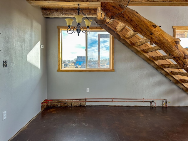 additional living space with concrete flooring, wood ceiling, stairway, beamed ceiling, and an inviting chandelier