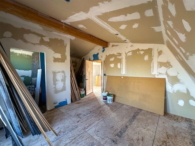 miscellaneous room with vaulted ceiling with beams