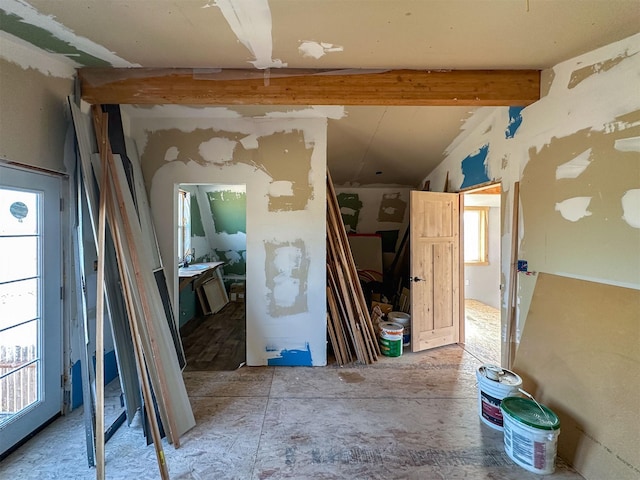 interior space featuring lofted ceiling with beams