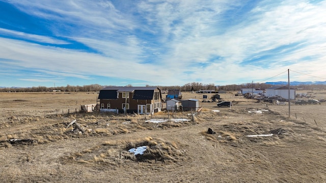 view of yard with a rural view and an outdoor structure