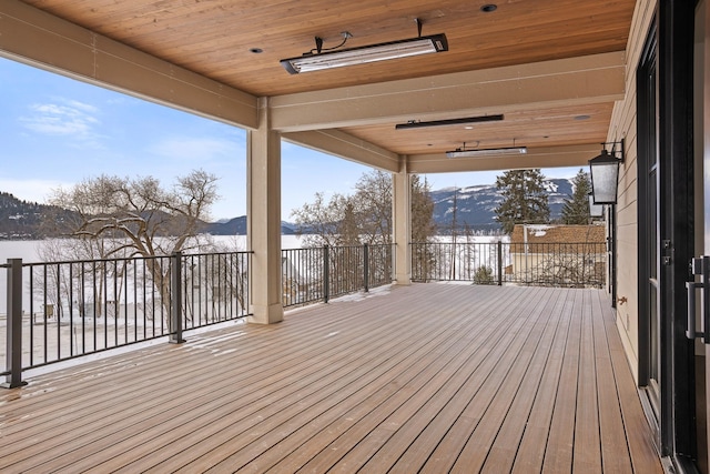 snow covered deck featuring a mountain view