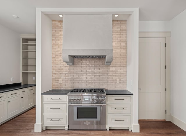 kitchen featuring dark countertops, high end stainless steel range oven, and wood finished floors