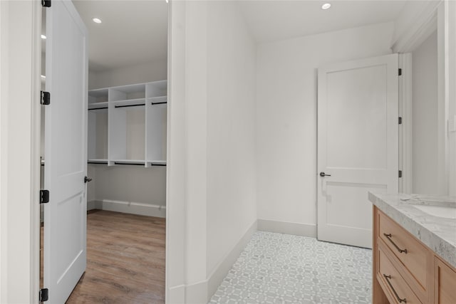 bathroom featuring recessed lighting, vanity, and baseboards