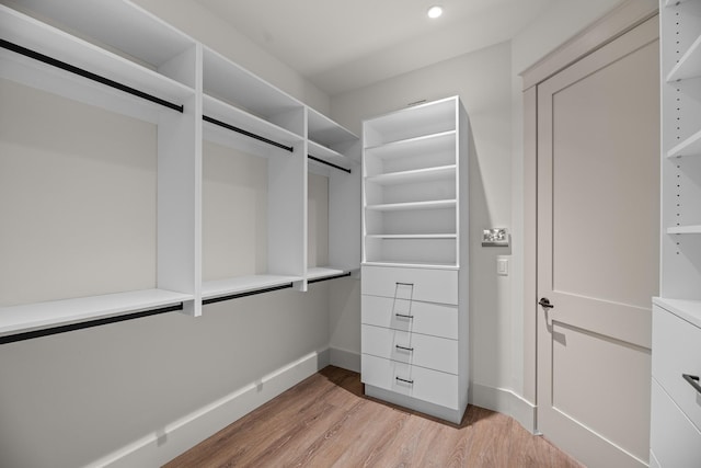 walk in closet with light wood-type flooring