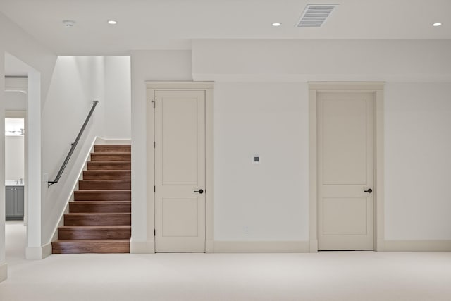 staircase featuring recessed lighting, visible vents, and baseboards