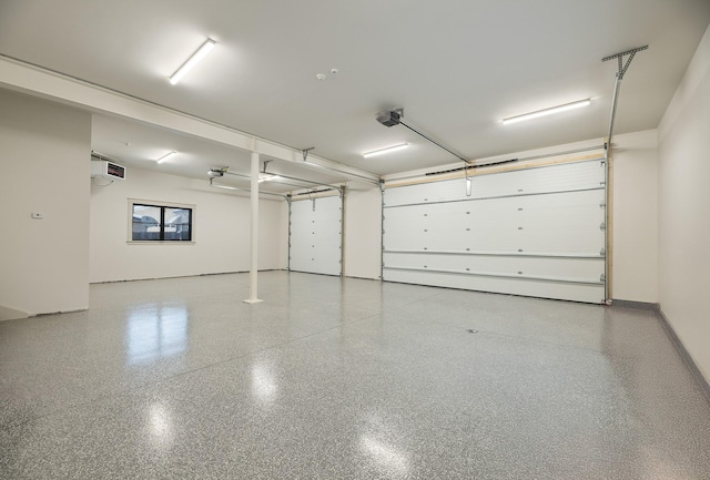 garage with baseboards and a garage door opener