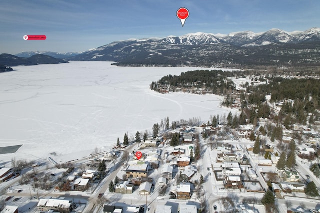 snowy aerial view with a mountain view