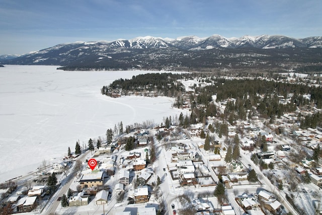 snowy aerial view featuring a mountain view