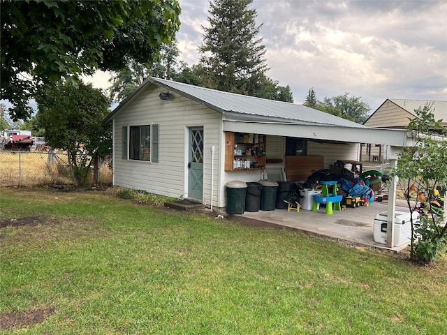 view of outbuilding with fence