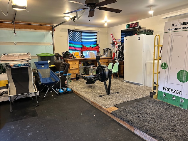 garage featuring freestanding refrigerator and a ceiling fan