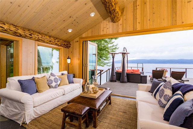 living room featuring lofted ceiling, wood walls, wood ceiling, and a water view