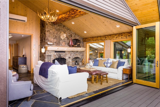 living area with wood ceiling, a wall unit AC, a stone fireplace, and hardwood / wood-style flooring