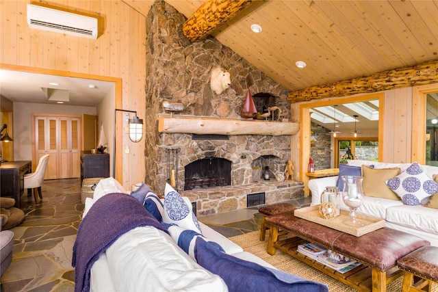 living room with a wall mounted AC, wood ceiling, stone finish flooring, a stone fireplace, and beamed ceiling