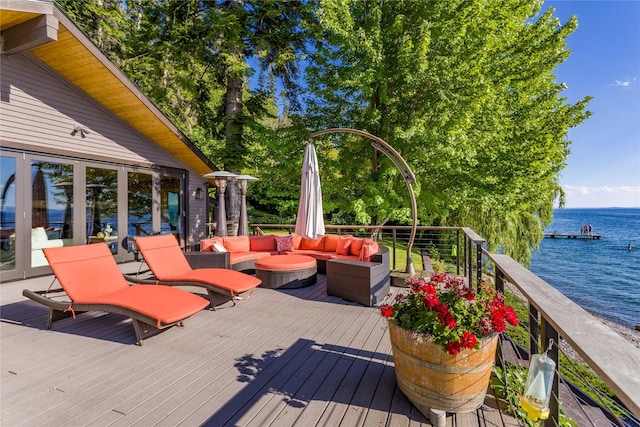 wooden terrace with a water view and an outdoor living space