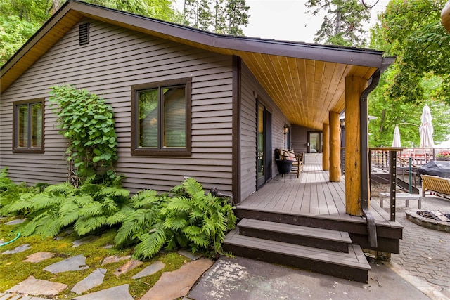 exterior space featuring a fire pit and a deck