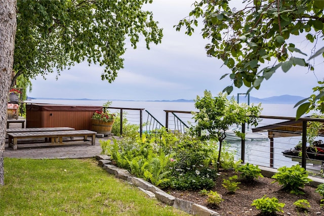 view of yard with a hot tub, a mountain view, and a patio