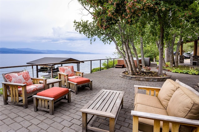 view of patio with a water view and outdoor lounge area