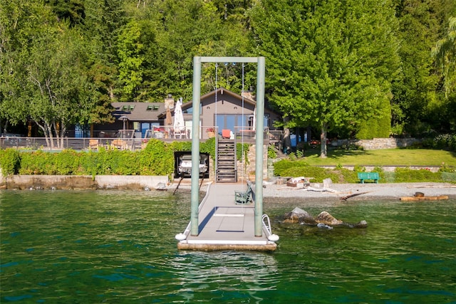 view of dock featuring stairs and a water view