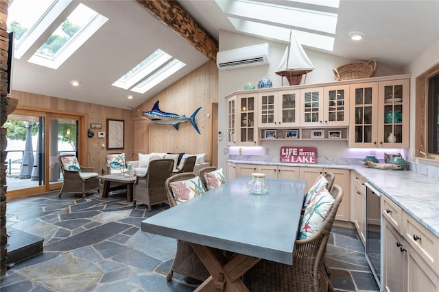 dining space featuring stone tile floors, wooden walls, beverage cooler, a wall unit AC, and lofted ceiling with beams