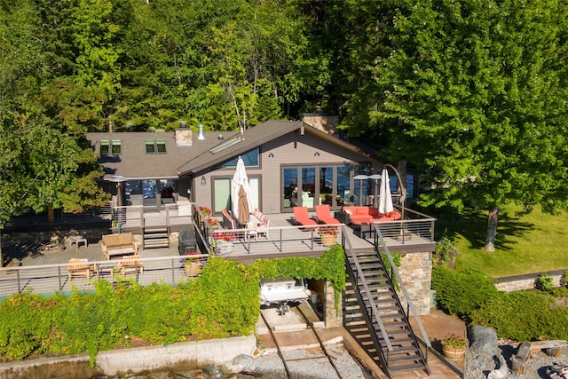 rear view of property with fence, a patio, a chimney, and stairs