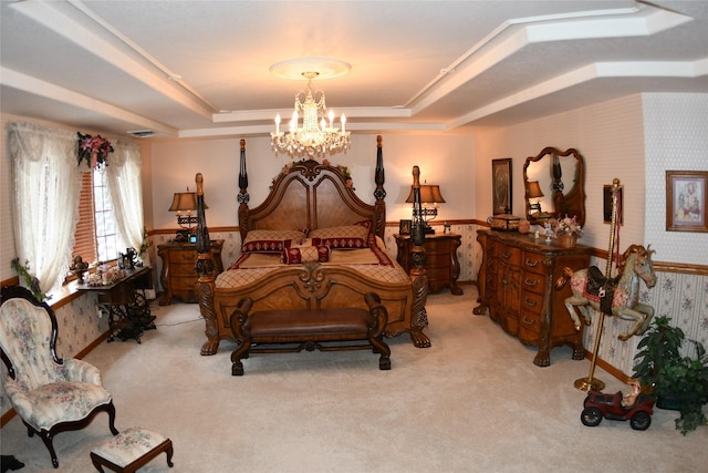 bedroom with wainscoting, a raised ceiling, light colored carpet, and wallpapered walls