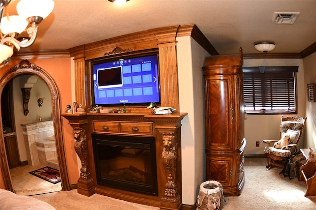 interior space with a large fireplace, ornamental molding, light carpet, and visible vents