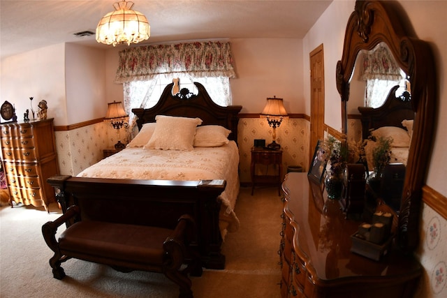 bedroom with carpet floors, wainscoting, visible vents, and wallpapered walls