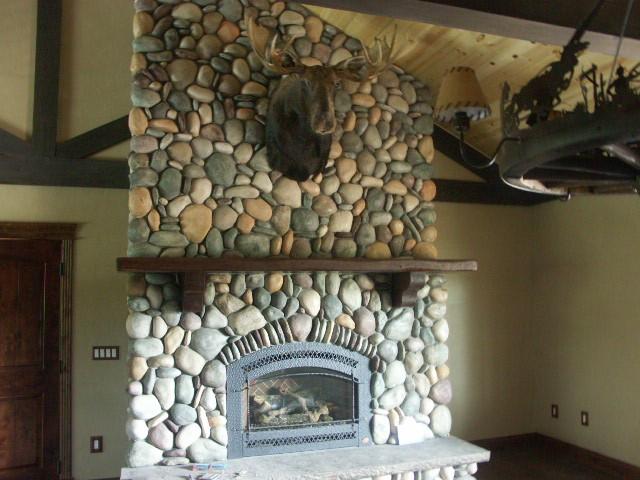 details featuring a stone fireplace, beam ceiling, and baseboards