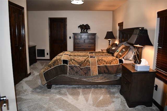 bedroom with carpet floors and baseboards