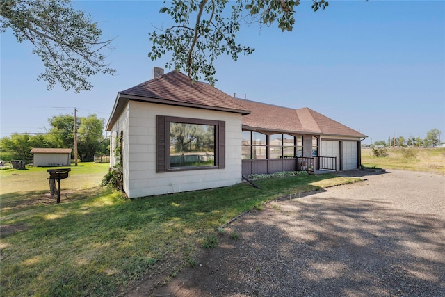 exterior space featuring roof with shingles, a lawn, and a chimney