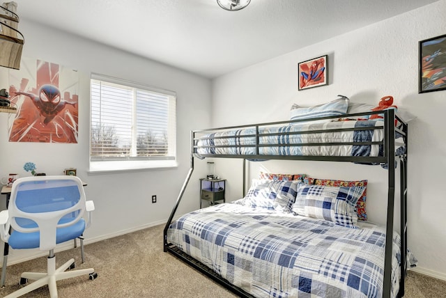 carpeted bedroom featuring baseboards