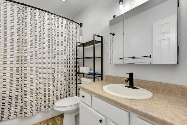 full bath featuring toilet and vanity