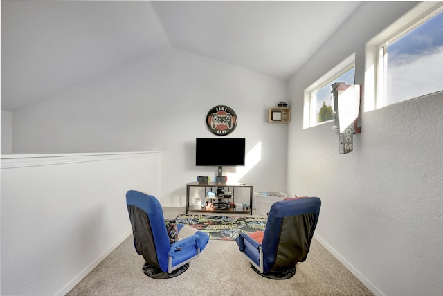 sitting room with vaulted ceiling, carpet flooring, and baseboards