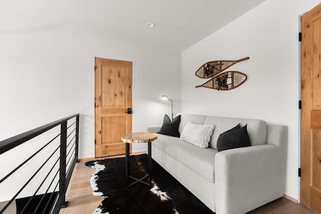 living area with wood finished floors and recessed lighting