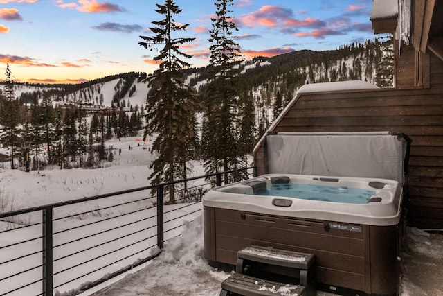 exterior space featuring a mountain view and a hot tub