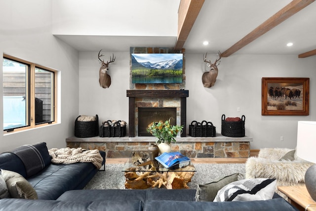 living area with a fireplace, beamed ceiling, and recessed lighting