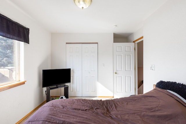 bedroom with a closet and baseboards