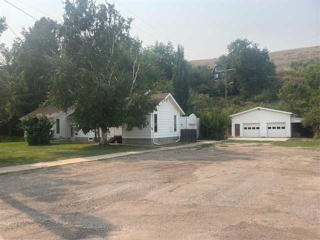 exterior space featuring an outbuilding, a detached garage, and central air condition unit