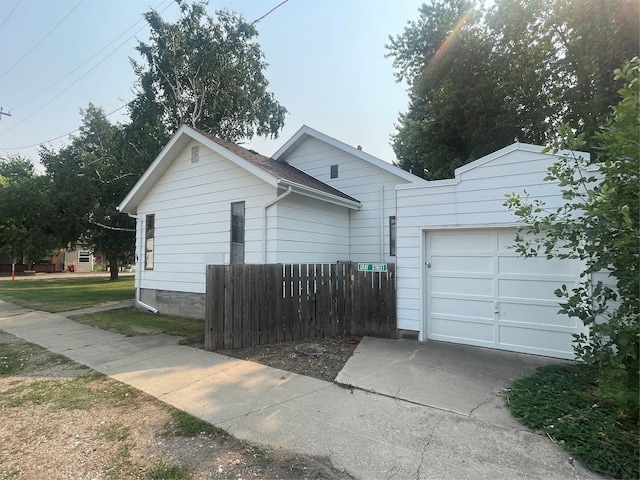 view of property exterior with a garage and driveway