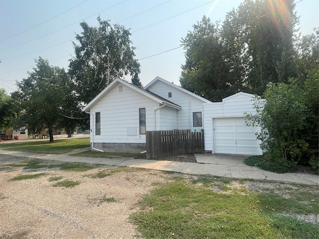 view of home's exterior featuring fence and an attached garage