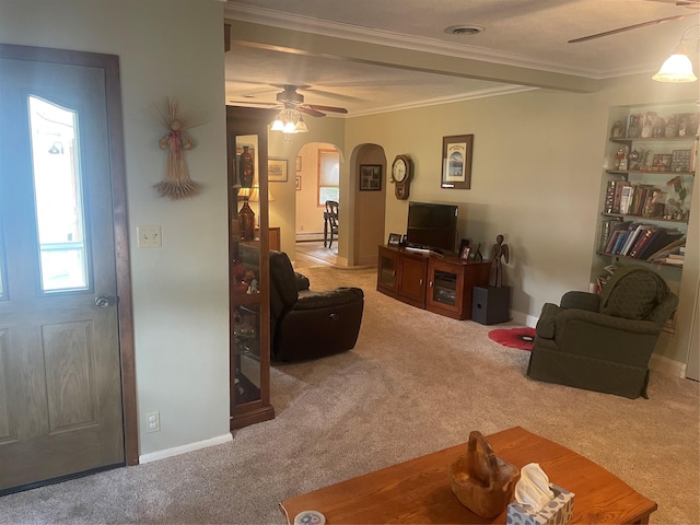 living area with visible vents, arched walkways, a ceiling fan, ornamental molding, and carpet flooring