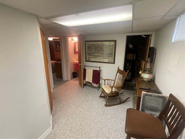 corridor featuring carpet and a drop ceiling