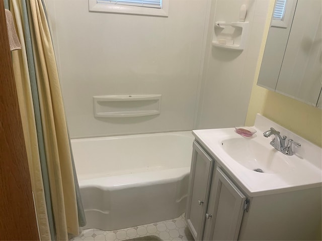 bathroom with shower / tub combo, vanity, and tile patterned floors