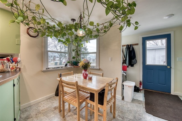 dining space featuring plenty of natural light and baseboards