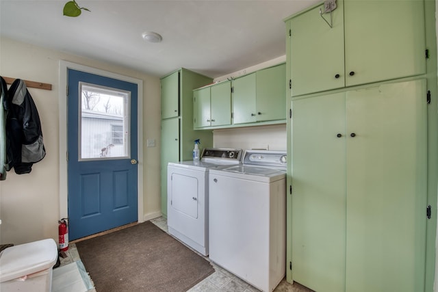 laundry room with washing machine and clothes dryer and cabinet space