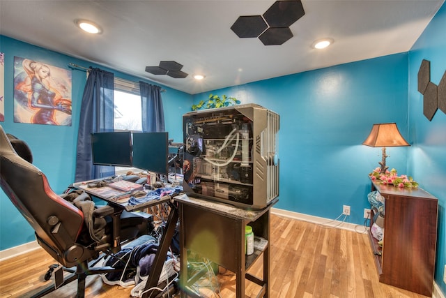 home office with recessed lighting, wood finished floors, and baseboards