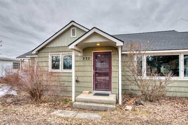 view of front of home with a shingled roof