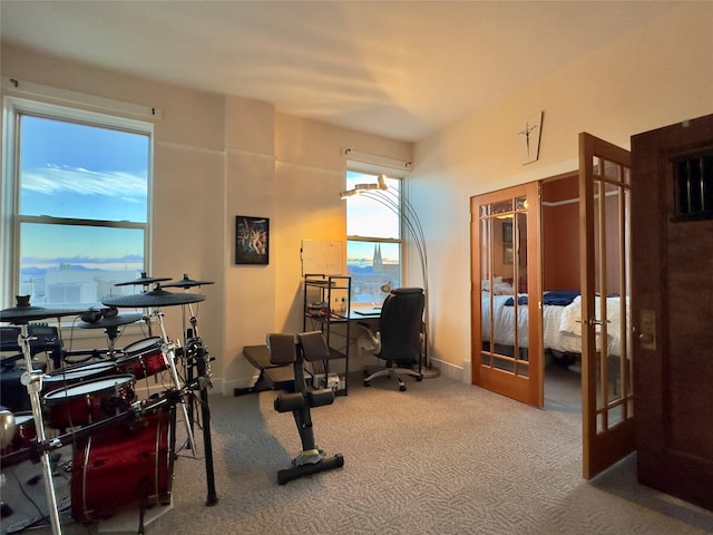 carpeted office space with french doors and baseboards